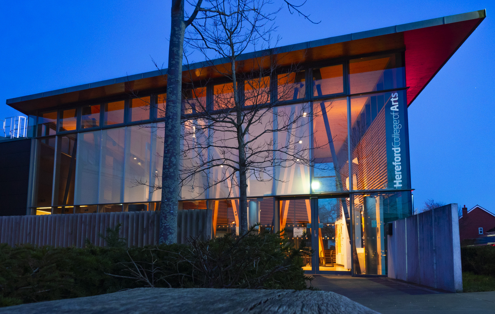 The contemporary glass and timber entrance of a UK arts college